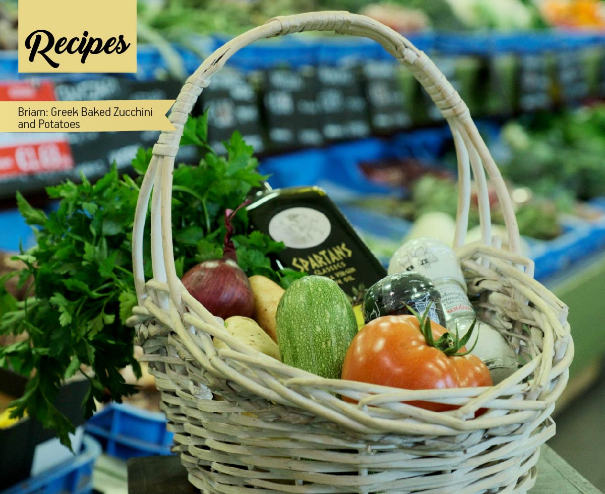 Photo with a basket with vegetables and a bottle of olive oil